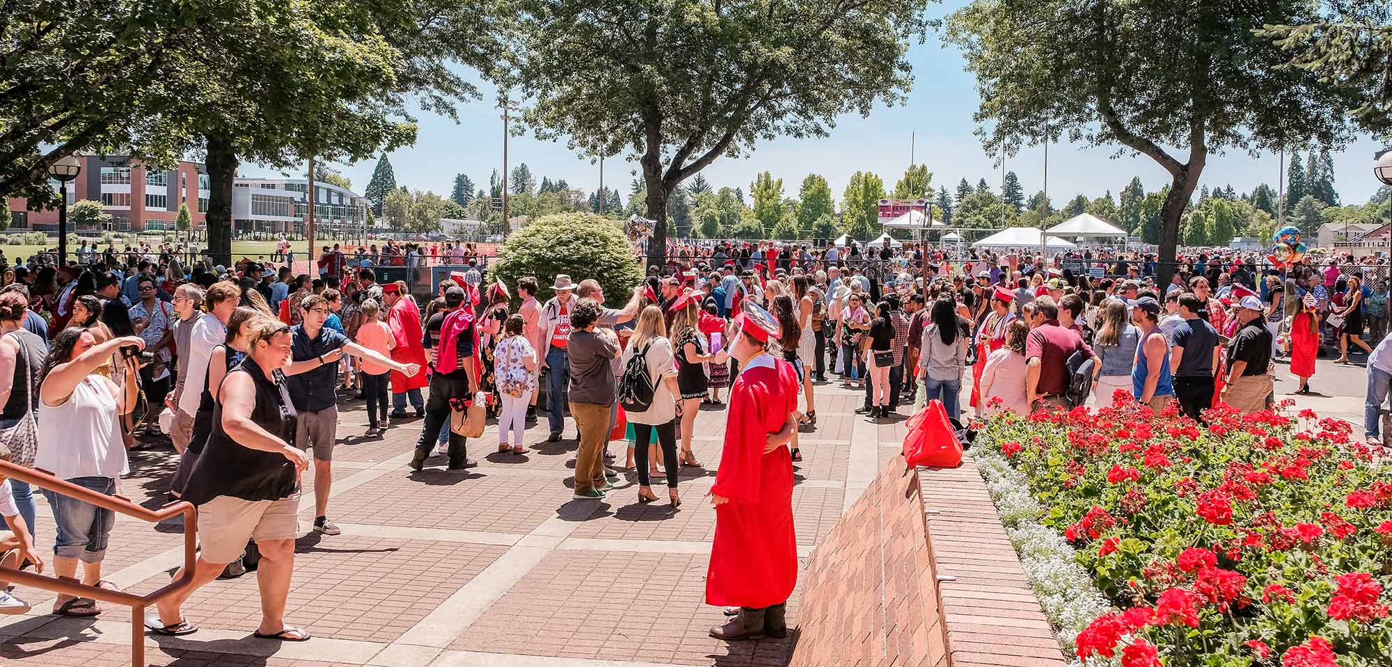 WOU grads gathering outside.