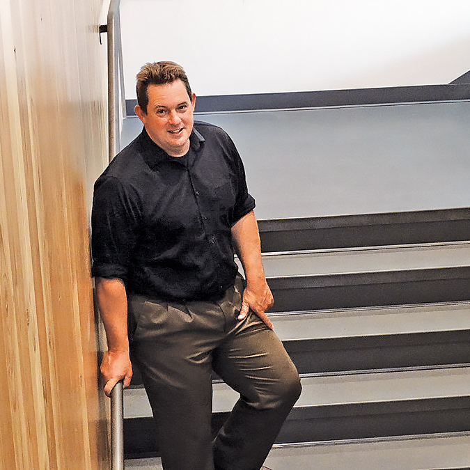 mark standing on the stairs in the Richard Woodcock Education Center