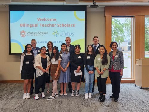 bilingual and diverse teacher scholars pose with faculty and staff