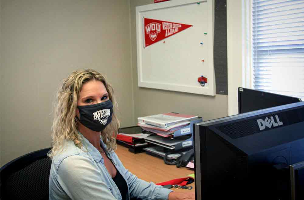 WOU-employee-wearing-a-mask WOU employee wearing a mask at her desk