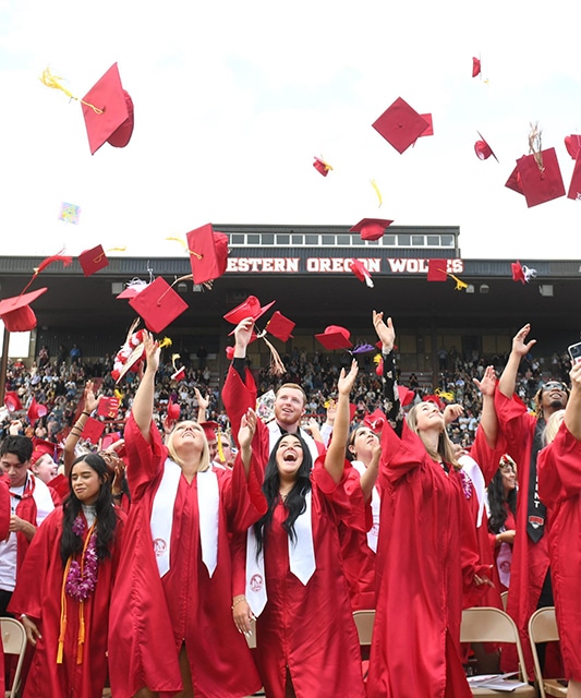Image of graduates throwing caps in the air