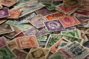19851046-colorful-vintage-used-postage-stamps-in-a-pile