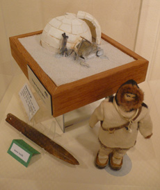 Temporary snow iglu, snow knife, doll