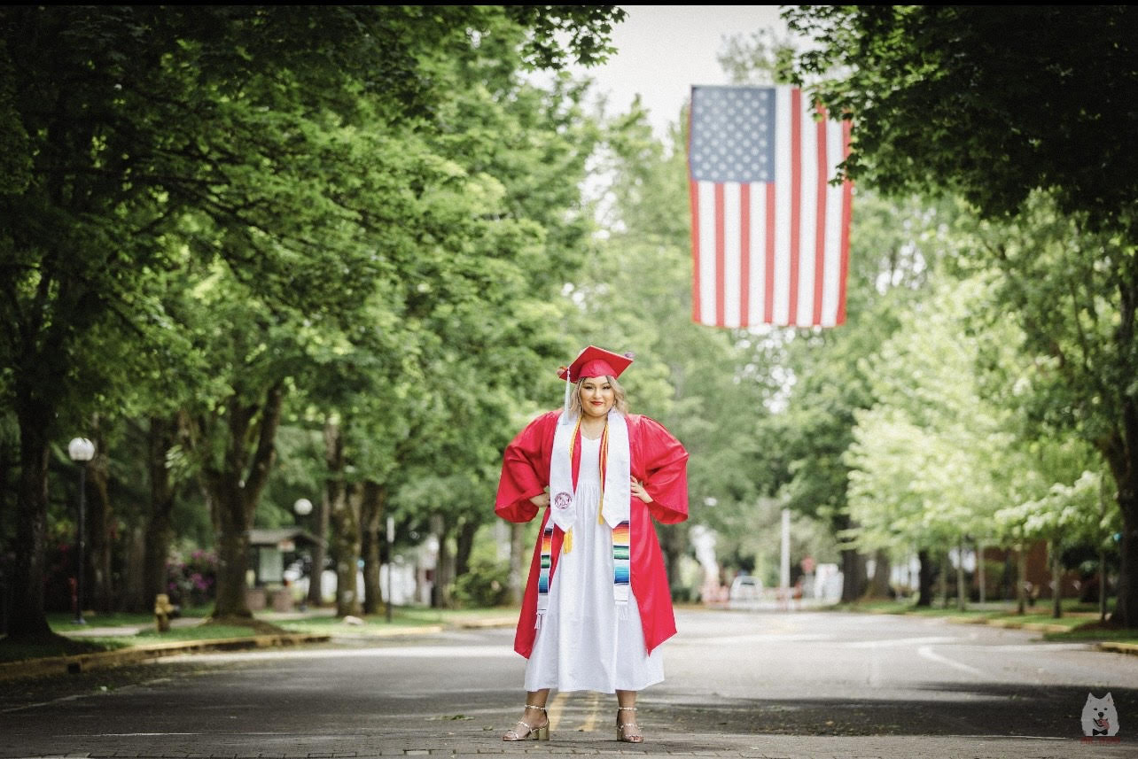 WOU graduate posing proudly