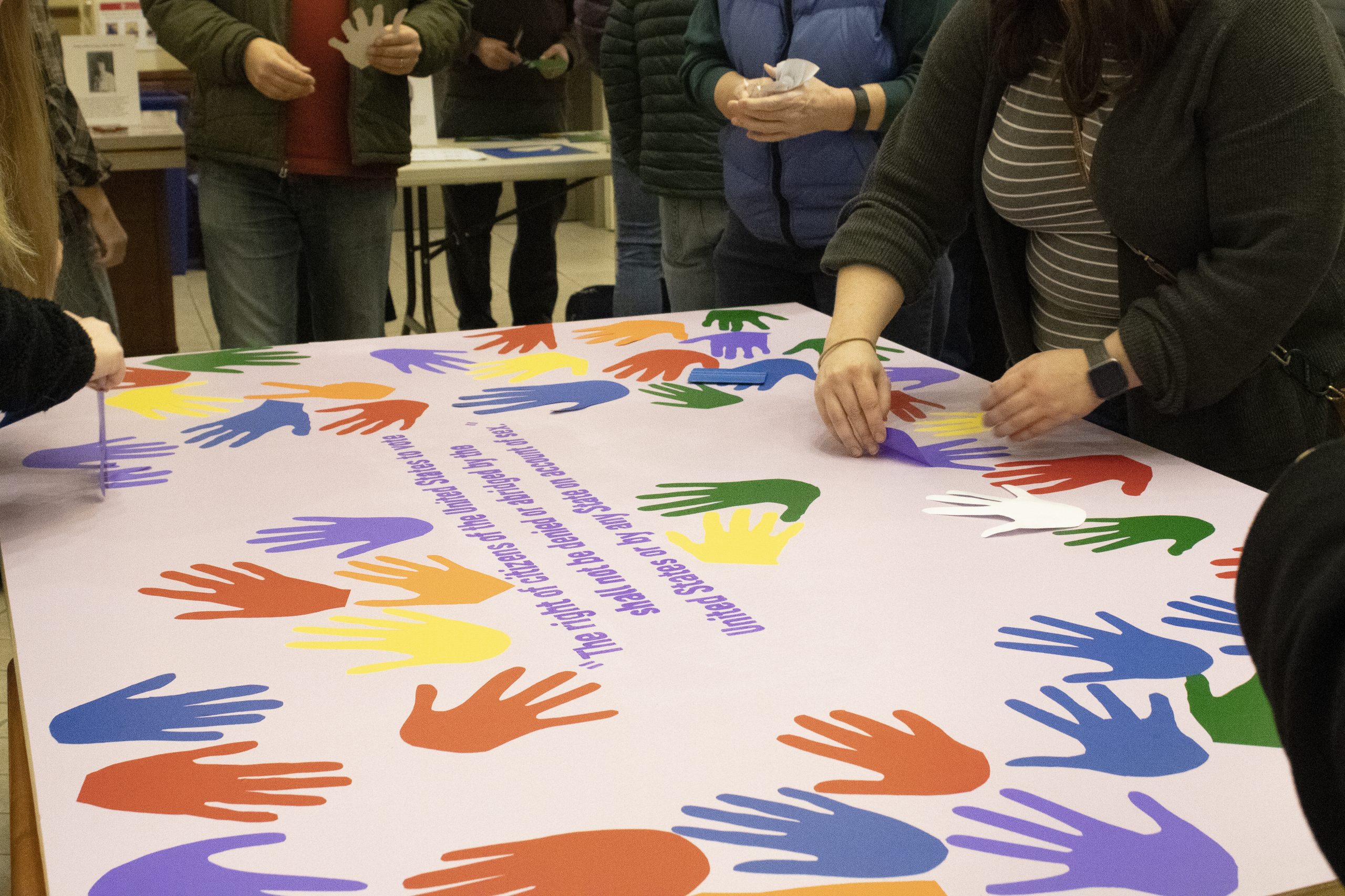 Students and faculty collaborate to create a mural commemorating the anniversary of the 19th amendment to be displayed in Hamersly Library.
